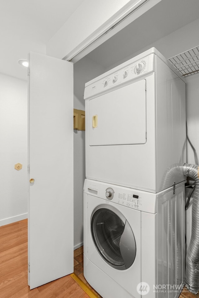 10329 Meridian Ave N Unit A201, Seattle, WA 98133 - washroom featuring stacked washing machine and dryer and light wood-type flooring