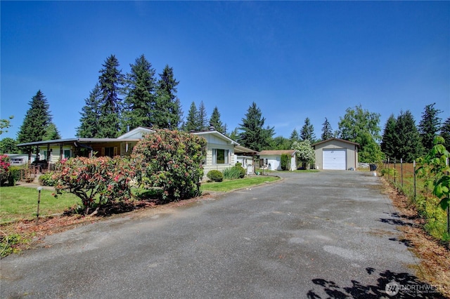 22665 Mosier Rd, Sedro Woolley, WA 98284 - view of front of home with an outdoor structure, asphalt driveway, and a garage