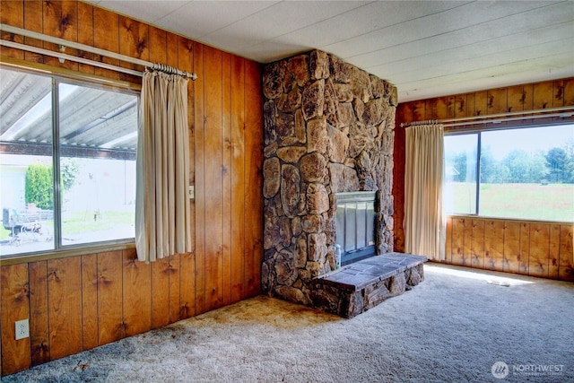 22665 Mosier Rd, Sedro Woolley, WA 98284 - unfurnished living room with wooden walls, carpet, and a stone fireplace