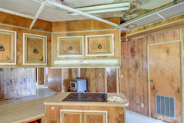 22665 Mosier Rd, Sedro Woolley, WA 98284 - kitchen with wood walls, a wood stove, and a center island