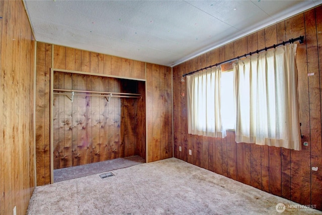 22665 Mosier Rd, Sedro Woolley, WA 98284 - unfurnished bedroom with wood walls, carpet flooring, and a closet