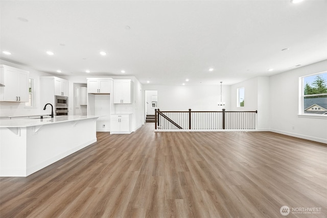 15602 210th Ave E Unit 314, Bonney Lake, WA 98391 - unfurnished living room with light wood finished floors and recessed lighting