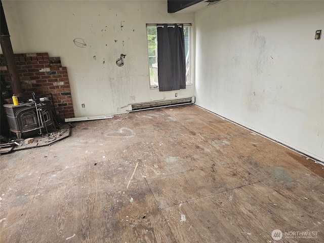 39 Otters Lair Ln, Orcas Island, WA 98245 - unfurnished living room featuring a wood stove and baseboard heating