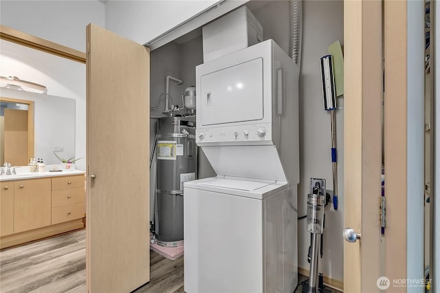 14525 1st Ln NE Unit C, Duvall, WA 98019 - washroom with stacked washer / dryer, water heater, and light wood-type flooring