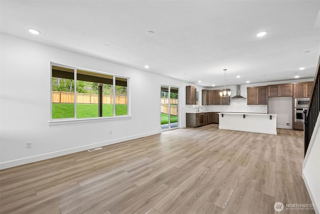 15612 210th Ave E Unit 313, Bonney Lake, WA 98391 - unfurnished living room with recessed lighting, light wood-style floors, a sink, and baseboards