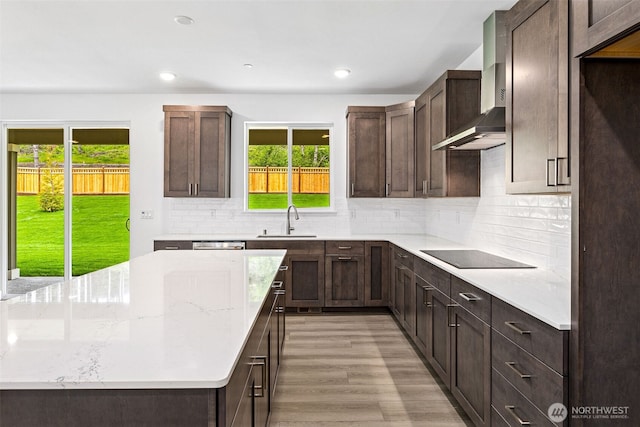 15612 210th Ave E Unit 313, Bonney Lake, WA 98391 - kitchen featuring black electric stovetop, wall chimney exhaust hood, a sink, plenty of natural light, and recessed lighting