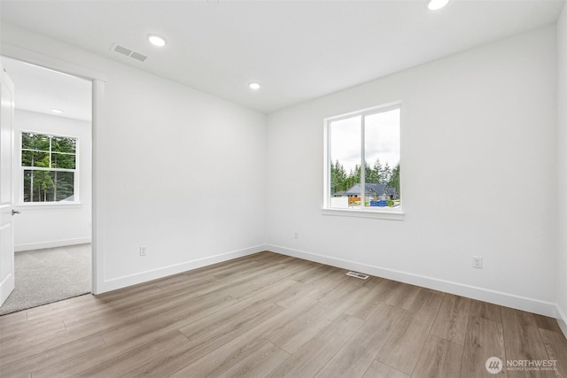 15612 210th Ave E Unit 313, Bonney Lake, WA 98391 - spare room with light wood-style floors, baseboards, and recessed lighting