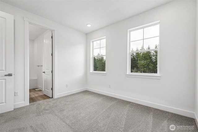 15612 210th Ave E Unit 313, Bonney Lake, WA 98391 - unfurnished bedroom with carpet flooring, baseboards, recessed lighting, and ensuite bath