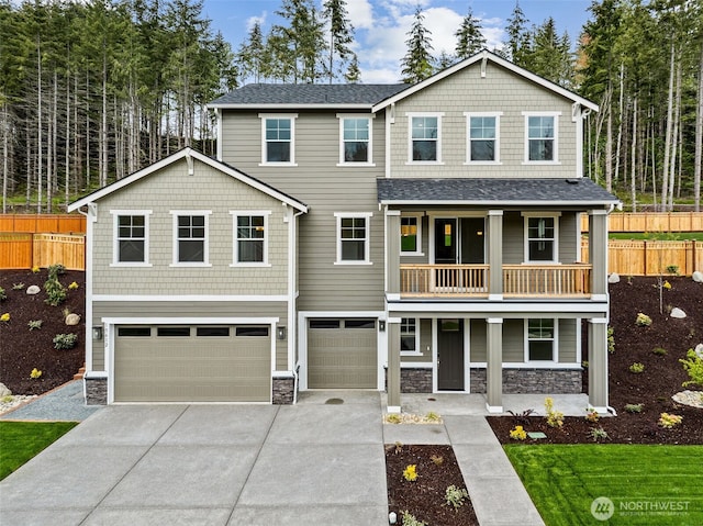 15612 210th Ave E Unit 313, Bonney Lake, WA 98391 - craftsman house featuring a balcony, stone siding, a garage, covered porch, and driveway
