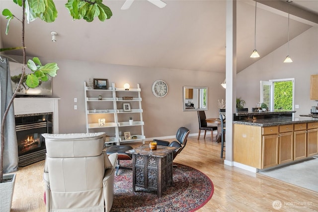 1402 E Lake Dr, Bremerton, WA 98312 - living room with light wood-style floors, a glass covered fireplace, baseboards, ceiling fan, and beamed ceiling