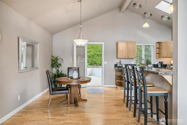 1402 E Lake Dr, Bremerton, WA 98312 - dining area featuring beam ceiling, a skylight, light wood-style floors, baseboards, and high vaulted ceiling