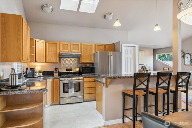 1402 E Lake Dr, Bremerton, WA 98312 - kitchen featuring open shelves, stainless steel appliances, under cabinet range hood, a breakfast bar area, and a skylight