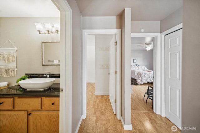 1402 E Lake Dr, Bremerton, WA 98312 - bathroom featuring vanity, wood finished floors, ensuite bathroom, and a ceiling fan