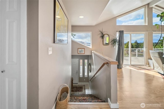 1402 E Lake Dr, Bremerton, WA 98312 - stairs with lofted ceiling, plenty of natural light, wood finished floors, and baseboards