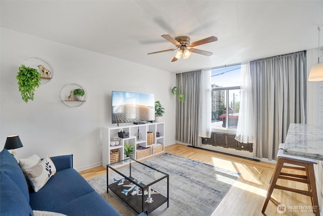 22 John St Unit 10, Seattle, WA 98109 - living room with ceiling fan, wood finished floors, and baseboards