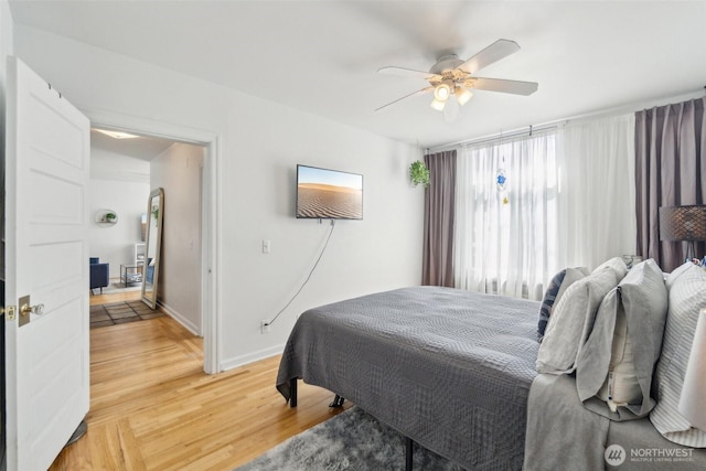 22 John St Unit 10, Seattle, WA 98109 - bedroom with light wood-type flooring, baseboards, and ceiling fan