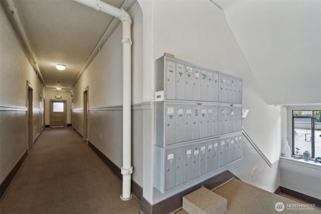 22 John St Unit 10, Seattle, WA 98109 - hall featuring mail area, baseboards, lofted ceiling, and carpet flooring