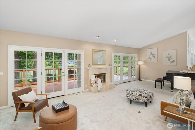 211 Greenview Ln, Port Ludlow, WA 98365 - living area with french doors, baseboards, carpet, a fireplace, and lofted ceiling