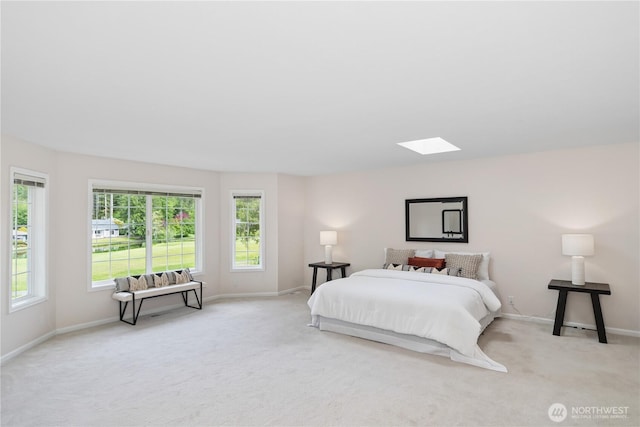 211 Greenview Ln, Port Ludlow, WA 98365 - bedroom featuring a skylight, light colored carpet, and baseboards