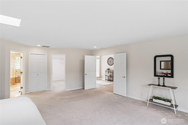 211 Greenview Ln, Port Ludlow, WA 98365 - unfurnished bedroom featuring light carpet, baseboards, a skylight, recessed lighting, and connected bathroom