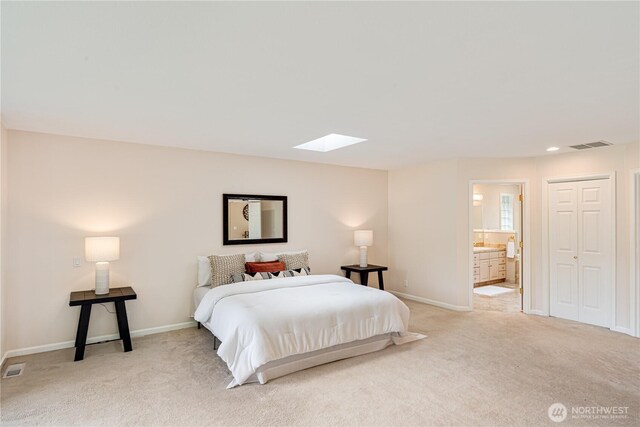 211 Greenview Ln, Port Ludlow, WA 98365 - bedroom featuring a skylight, light colored carpet, baseboards, and ensuite bathroom