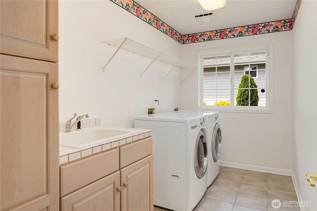 211 Greenview Ln, Port Ludlow, WA 98365 - laundry area with cabinet space, washing machine and clothes dryer, baseboards, and light tile patterned flooring