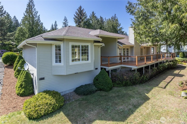 211 Greenview Ln, Port Ludlow, WA 98365 - back of property with a wooden deck, a lawn, roof with shingles, and a chimney