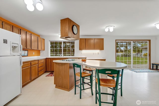 4716 266th St E, Spanaway, WA 98387 - kitchen featuring freestanding refrigerator, light countertops, black electric stovetop, and a kitchen island