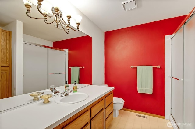4716 266th St E, Spanaway, WA 98387 - bathroom with toilet, vanity, a chandelier, a shower with shower door, and baseboards