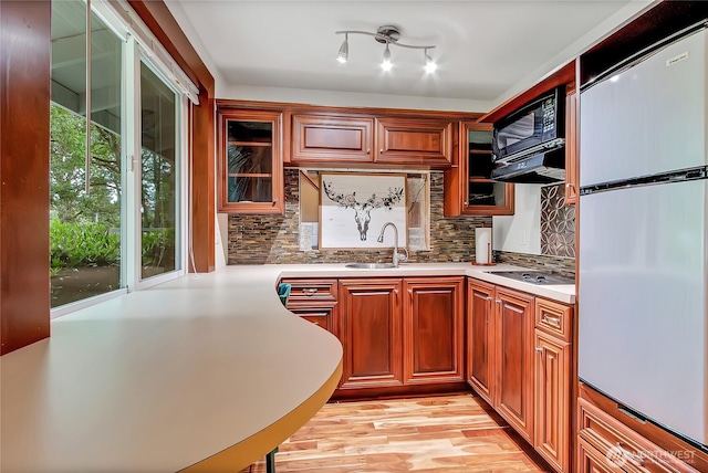 4716 266th St E, Spanaway, WA 98387 - kitchen with refrigerator, a sink, light countertops, and glass insert cabinets