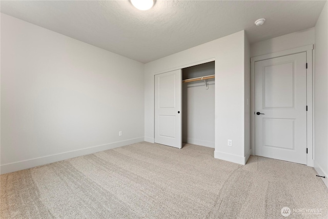 4215 W Sandy Ct, Moses Lake, WA 98837 - unfurnished bedroom featuring carpet flooring, baseboards, a closet, and a textured ceiling