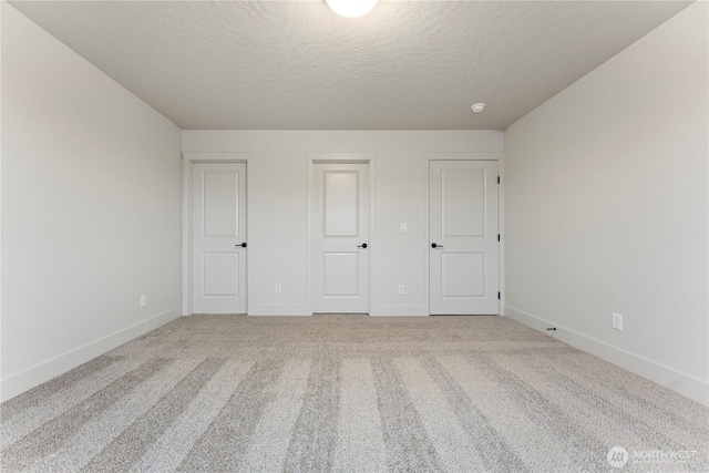 4215 W Sandy Ct, Moses Lake, WA 98837 - unfurnished bedroom featuring carpet floors, a textured ceiling, and baseboards