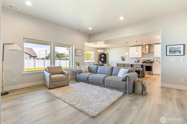 4208 W Sandy Ct, Moses Lake, WA 98837 - living room with light wood finished floors, recessed lighting, and a chandelier