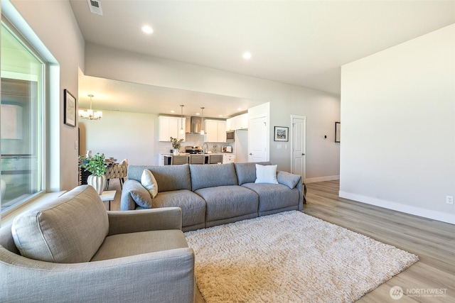 4208 W Sandy Ct, Moses Lake, WA 98837 - living room featuring light wood finished floors, a chandelier, and recessed lighting