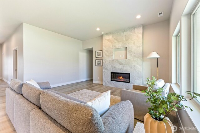 4208 W Sandy Ct, Moses Lake, WA 98837 - living area with light wood-style floors, a premium fireplace, recessed lighting, and healthy amount of natural light