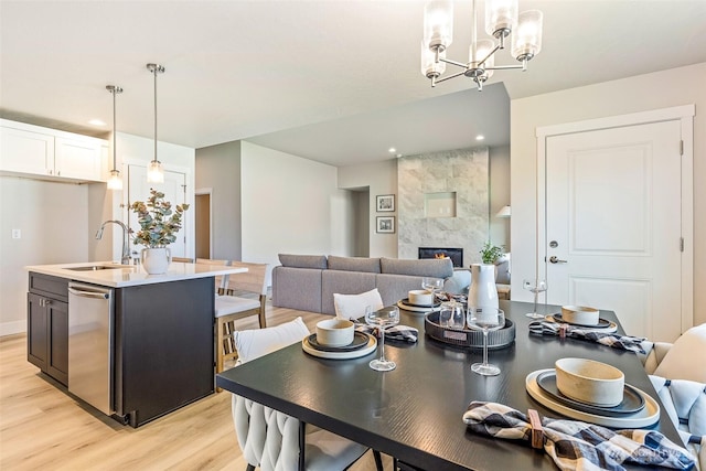 4208 W Sandy Ct, Moses Lake, WA 98837 - dining area featuring light wood finished floors, a tile fireplace, recessed lighting, and a chandelier
