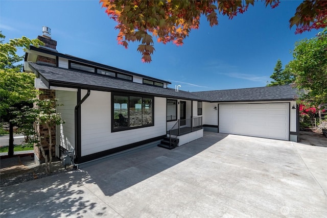 3020 Alpine Dr, Bellingham, WA 98226 - view of front facade featuring driveway, an attached garage, a chimney, and a shingled roof