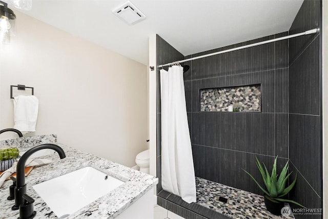 3020 Alpine Dr, Bellingham, WA 98226 - bathroom featuring toilet, tiled shower, and double vanity