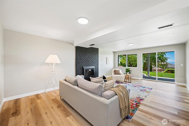3020 Alpine Dr, Bellingham, WA 98226 - living area with baseboards, light wood-style flooring, and a brick fireplace