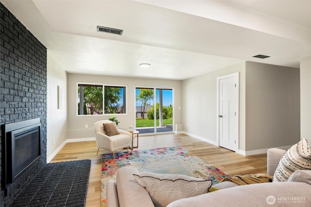 3020 Alpine Dr, Bellingham, WA 98226 - living area with a brick fireplace, wood finished floors, and baseboards