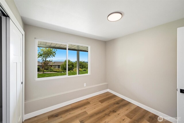 3020 Alpine Dr, Bellingham, WA 98226 - unfurnished bedroom featuring baseboards, wood finished floors, and a closet