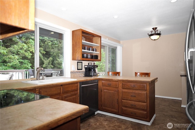 3521 170th Ave E, Lake Tapps, WA 98391 - kitchen featuring a peninsula, black appliances, light countertops, a sink, and open shelves