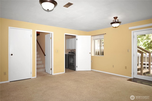 3521 170th Ave E, Lake Tapps, WA 98391 - unfurnished living room with stairs, baseboards, and light colored carpet