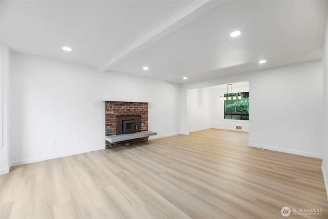9828 33rd Dr SE, Everett, WA 98208 - unfurnished living room featuring light wood finished floors, recessed lighting, baseboards, beamed ceiling, and a fireplace