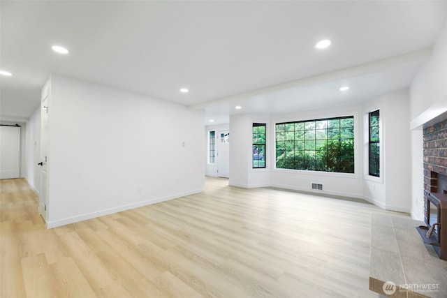 9828 33rd Dr SE, Everett, WA 98208 - unfurnished living room featuring a fireplace, light wood finished floors, recessed lighting, and baseboards