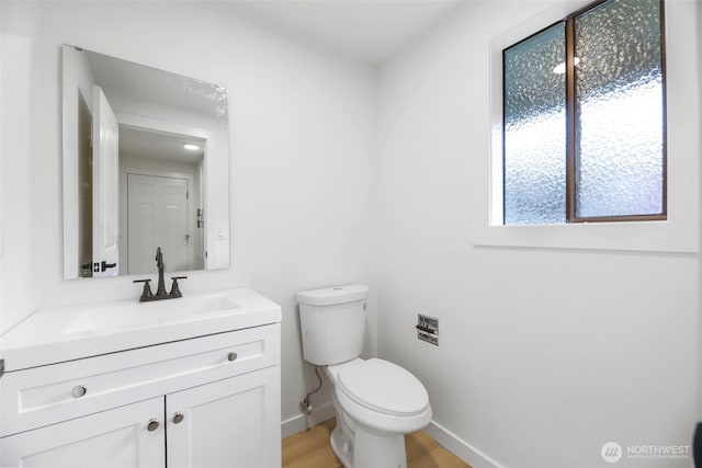 9828 33rd Dr SE, Everett, WA 98208 - bathroom with toilet, vanity, baseboards, and wood finished floors