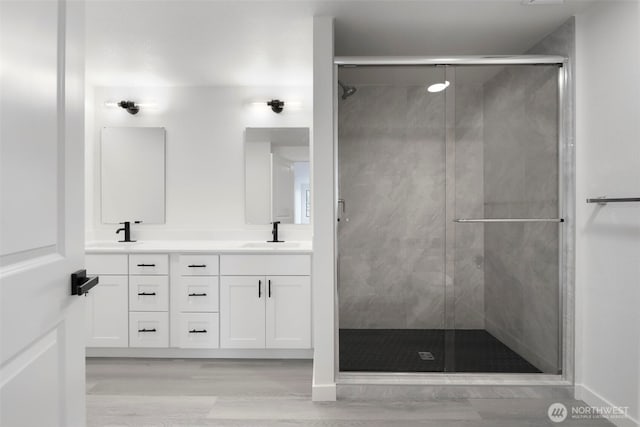 9828 33rd Dr SE, Everett, WA 98208 - bathroom featuring double vanity, a stall shower, and wood finished floors