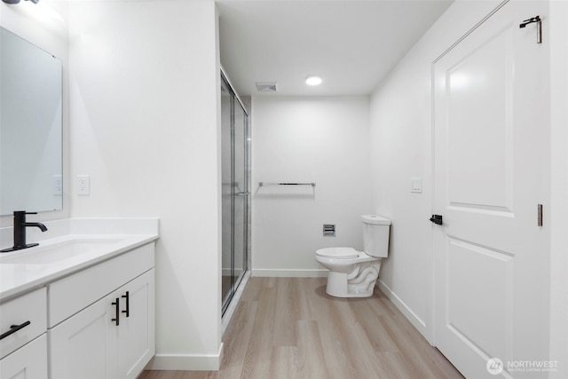 9828 33rd Dr SE, Everett, WA 98208 - full bathroom featuring toilet, vanity, wood finished floors, a shower stall, and baseboards