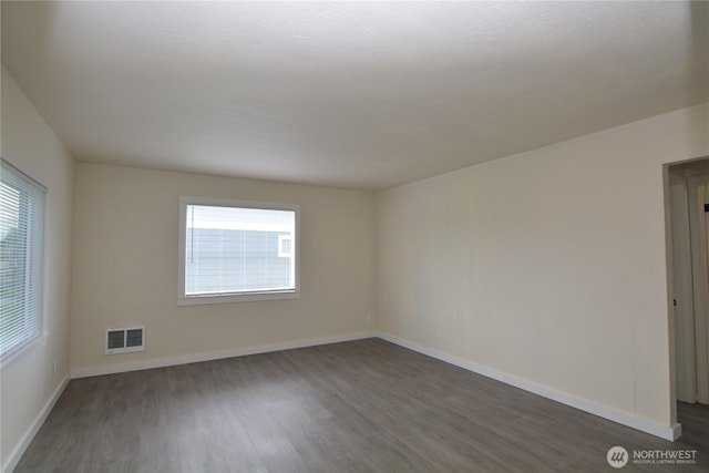 3159 Florida St, Longview, WA 98632 - empty room with dark wood-type flooring, plenty of natural light, and baseboards