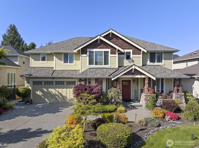 27 148th Pl SW, Lynnwood, WA 98087 - craftsman-style house featuring a garage, driveway, a porch, and roof with shingles